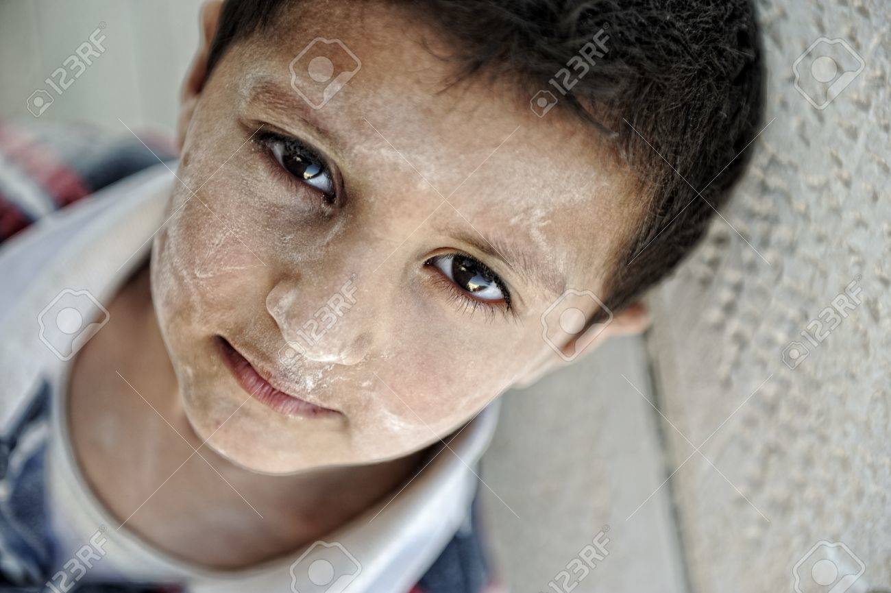 portrait of poverty little boy with sad eyes stock photo picture