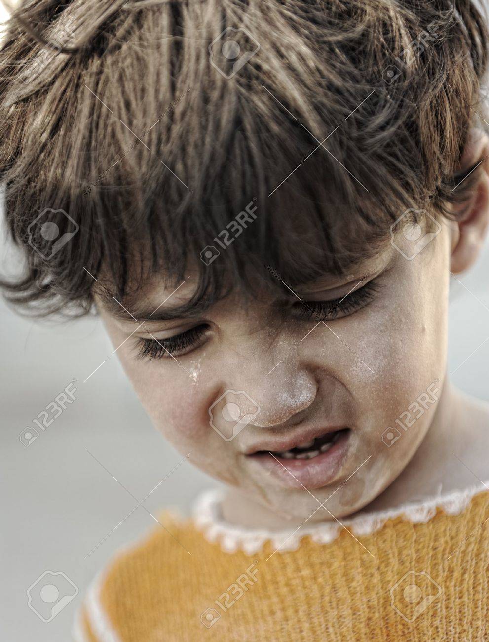 portrait of poverty little boy with sad look stock photo picture