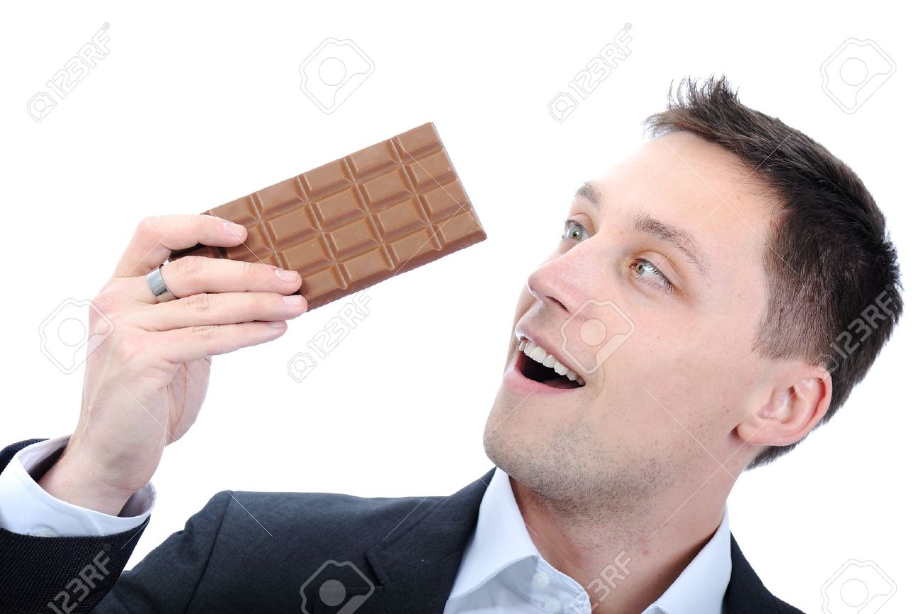 若いビジネス男を食べるチョコレート の写真素材 画像素材 Image