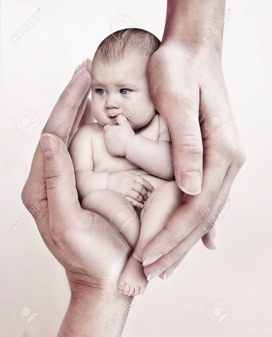 Palm Holds A Little Cute Baby On A Light Background Baby Care