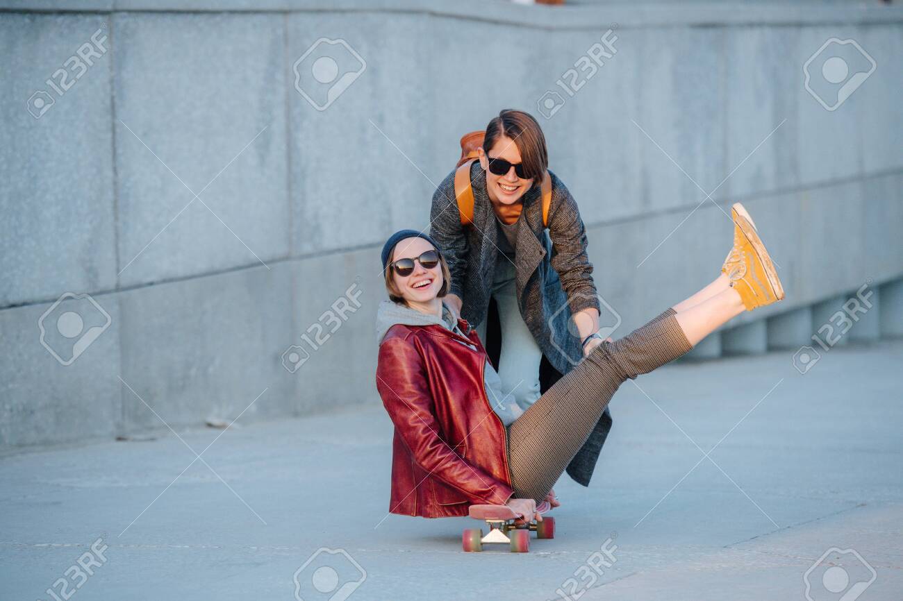 Portrait Of Two Young Amused Women With Short Hair In Sunglasses